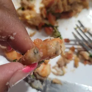 a hand holding a piece of food