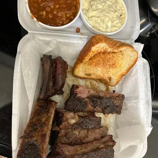 Half slab rib dinner with potato salad and BBQ baked beans. Texas toast on the side.