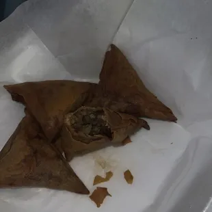 a close up of a piece of food in a paper bag