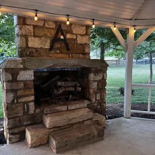 a stone fireplace in the back yard