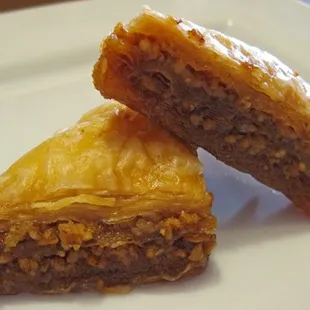 two pieces of baklaa on a white plate