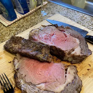 two slices of beef on a cutting board