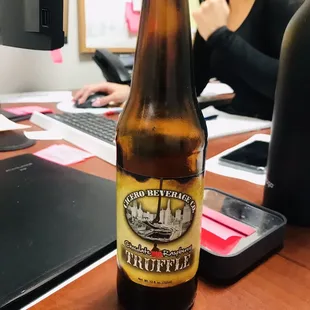 a bottle of beer on a desk