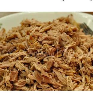 a plate of pulled pork with a fork