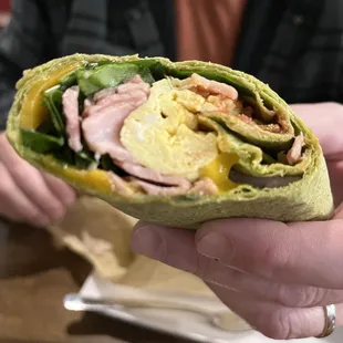 Breakfast burrito with ham, egg, spinach, cheddar cheese, onions, roasted peppers and salsa. DELISH!
