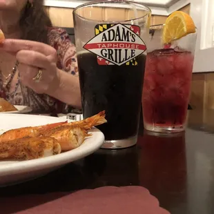 a woman eating pizza and a drink