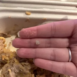 Rock found in beans and rice that I bit down on. Very painful and disappointing