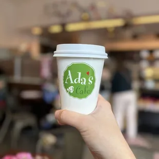 a hand holding a cup of coffee