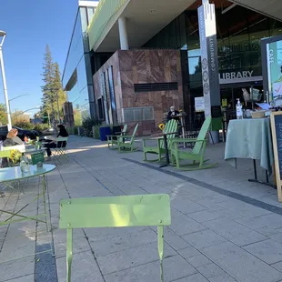 Plenty of outdoor seating, nicely spaced out with fresh sunflowers on each table