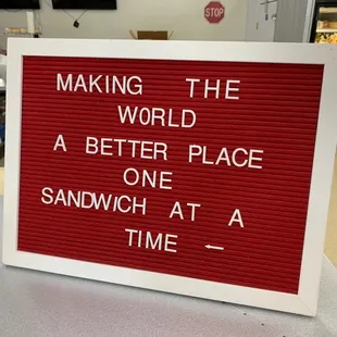 a sign that reads making the world a better place one sandwich at a time