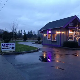 a small purple building on a rainy day