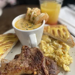 Lamb breakfast with shrimp and grits , toast and eggs .