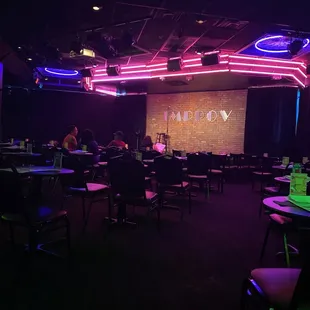 people sitting at tables in a dark room