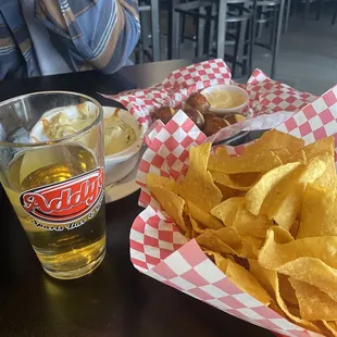 a plate of chips and a glass of beer
