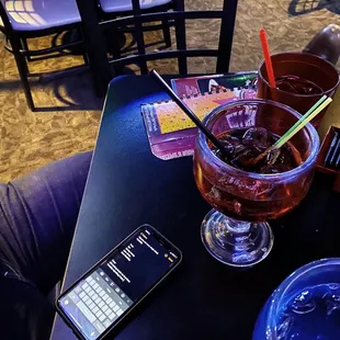 a drink and a cell phone