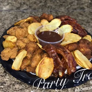 a plate of fried chicken, potatoes, and sauce
