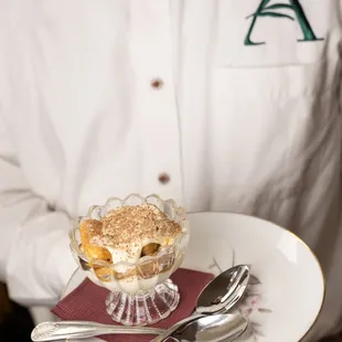 a man holding a plate of dessert