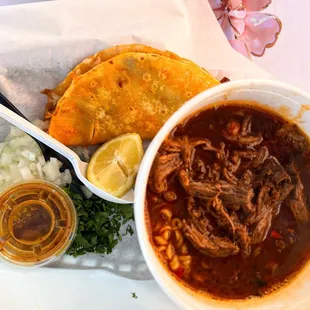 a bowl of soup, tortillas, and a tortilla