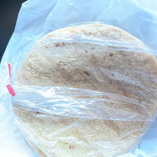 a tortilla wrapped in plastic wrap