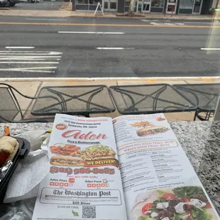 a menu and a sandwich on a table