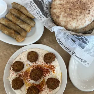 a plate of pita bread and a plate of sausages