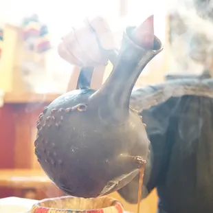 a vase being poured with hot chocolate