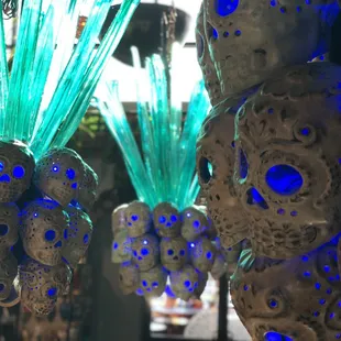 Original Blown glass agave chandeliers made with sugar skulls and vibrant led lighting. Check out our Artisan Market next door!