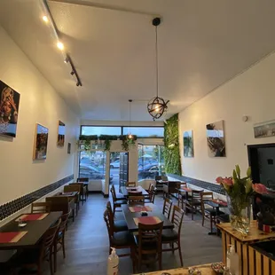 a view of a dining room with tables and chairs