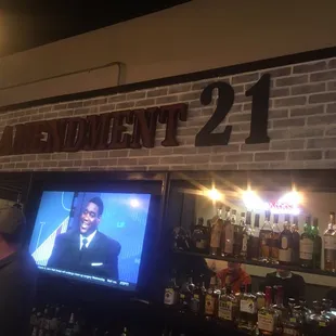 a television in front of a brick wall