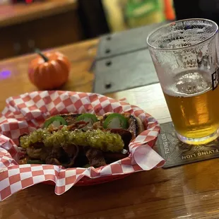 a plate of food and a glass of beer