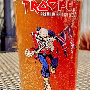 a glass of beer with a skeleton on it