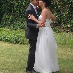 Bride and groom dancing on the grass