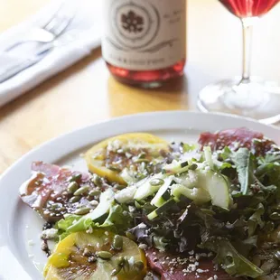 a plate of food and a glass of wine