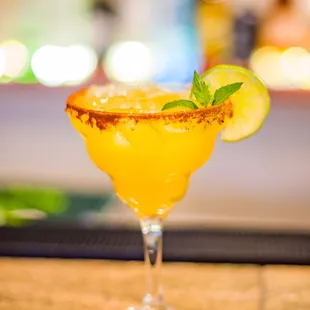 a margarita with a lime garnish on the rim