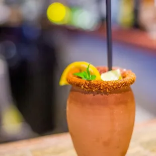 a drink with a garnish garnish on the rim