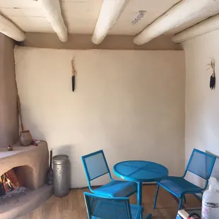 a table and chairs in front of a fireplace