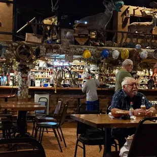 people sitting at tables in a restaurant