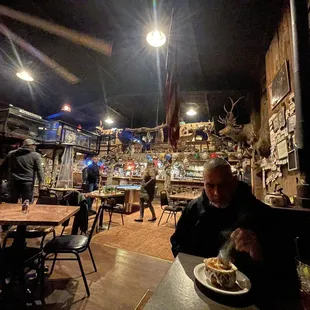 a man sitting at a table with a plate of food