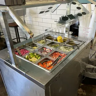Don&apos;t forget your condiments on your way out. Beans in the hotpot on the right