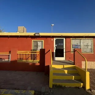 a red building with yellow stairs