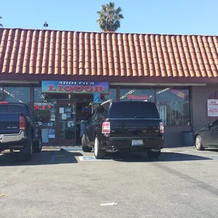 two trucks parked in front of the store