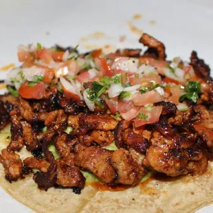 Pastor Taco ( Marinated Pork with Housemade Guacamole &amp; Housemade Pico de Gallo  in a Large Corn Tortilla.