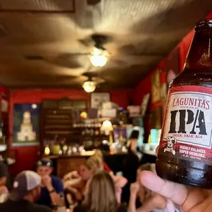a person holding a bottle of beer