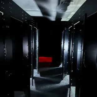 a dark hallway with red lighting