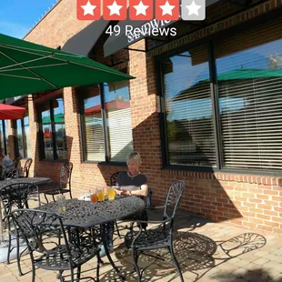 a patio with tables and umbrellas