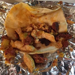 Taco special: fajita chicken, potato and chorizo. Opened up. Put cheese and rice inside after I took the pic.
