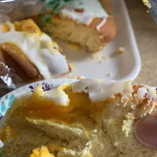 a hand holding a half eaten donut