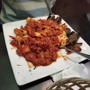 a plate of pasta and mussels