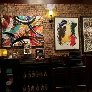 a brick wall with paintings on it