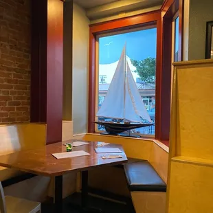 a table with a boat in the window